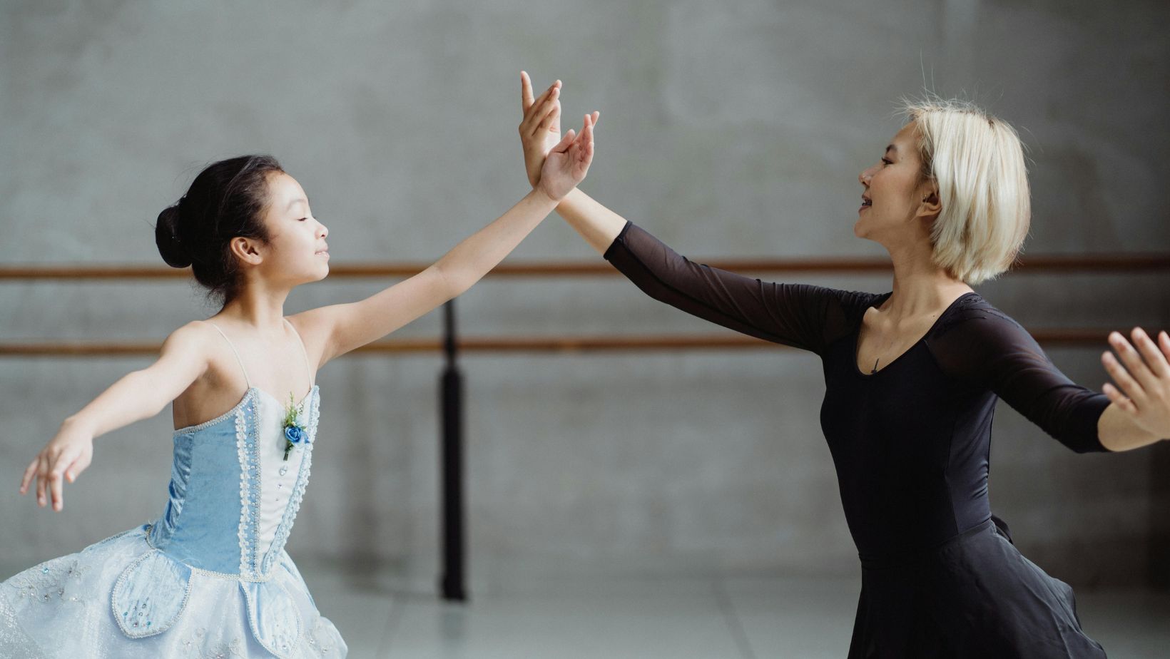 Teacher and students dancing in studio
