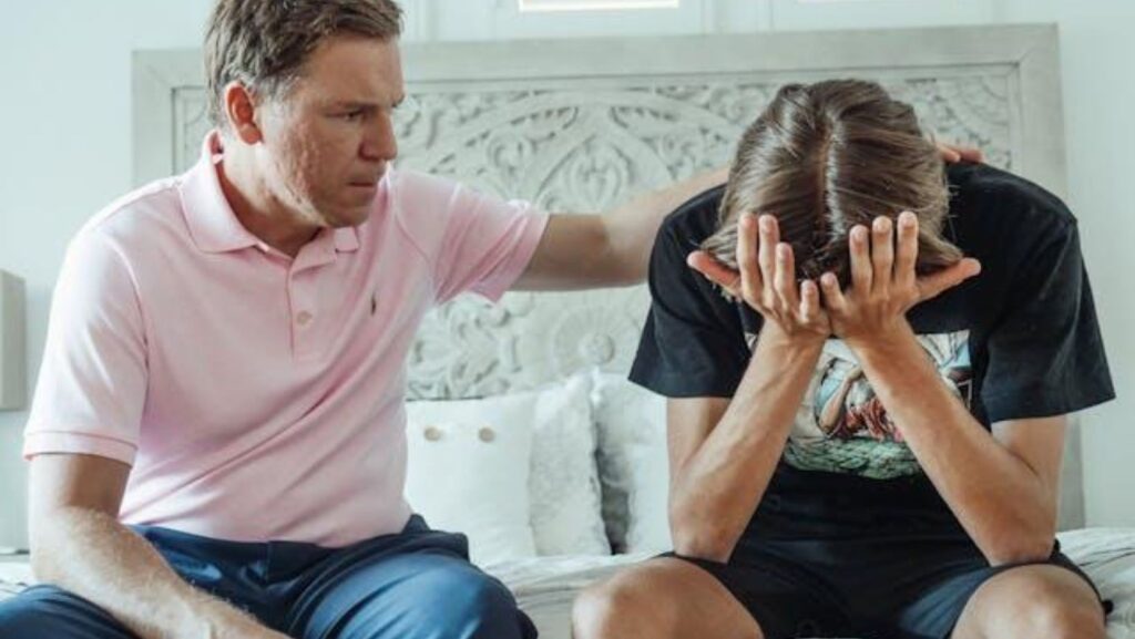 A father talking to a stressed teenager